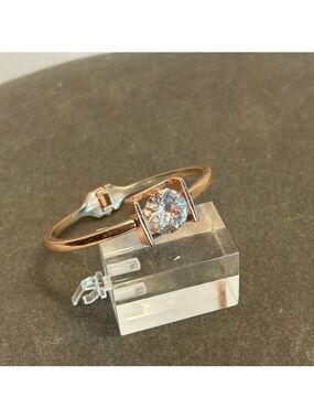 bracelet featuring large round clear gemstone set within square open-sided frame